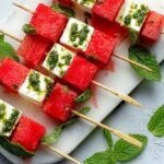 Watermelon feta mint skewers arranged on marble board for summer appetizer recipe