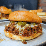 Delicious Philly Cheesesteak Sloppy Joes with melted provolone cheese on toasted buns
