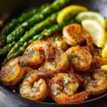 Lemon Garlic Shrimp and Asparagus served in a bowl with fresh herbs.