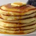 Stack of easy homemade pancakes with syrup and berries