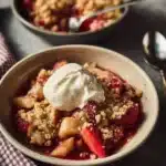 Freshly baked Strawberry Rhubarb Crumble dessert topped with a golden crispy layer.