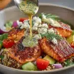 Mediterranean salmon rice bowl with fresh vegetables and herbs.